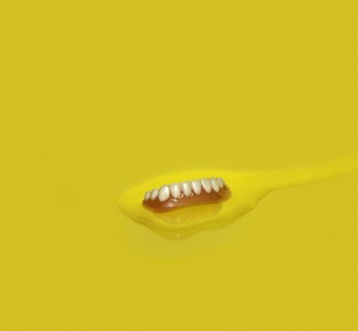 Teeth in a yellow liquid