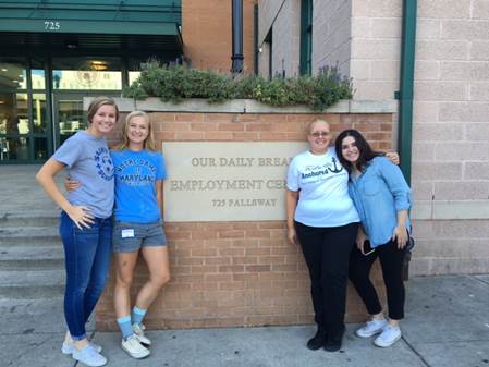 Students posing by Our Daily Bread sign