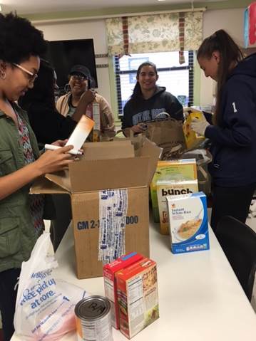Students filling boxes with food