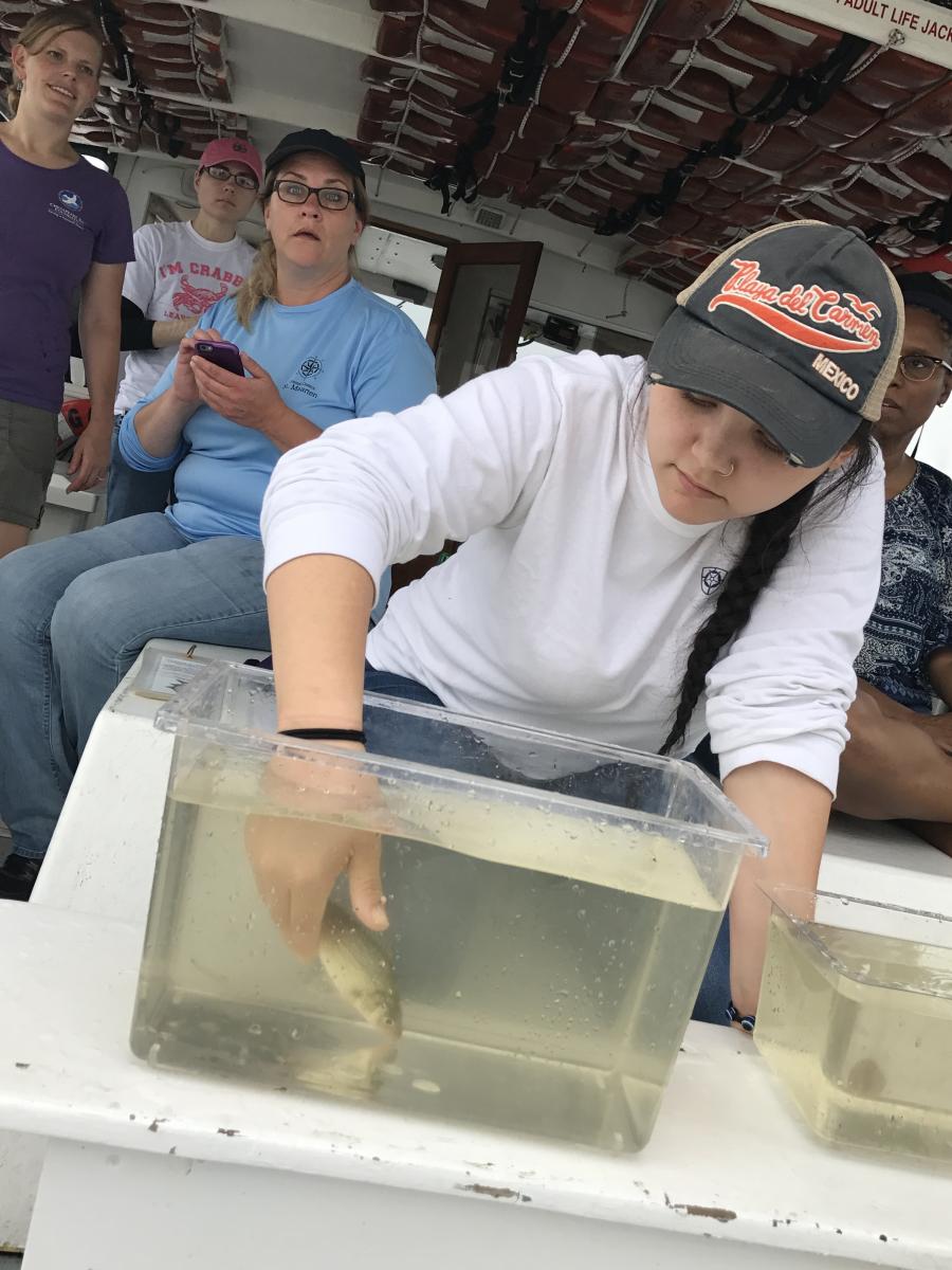 Life on Chesapeake student holds fish