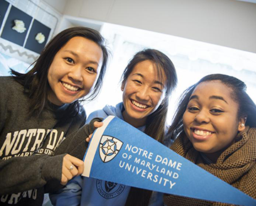 Students holding a Notre Dame pennant
