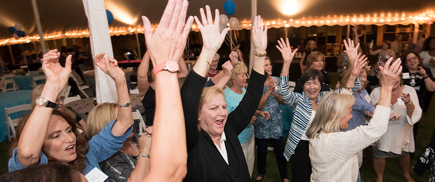 Women dancing with their hands in the air
