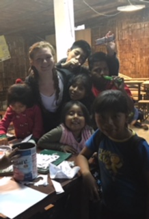 V Cox with children in Peru