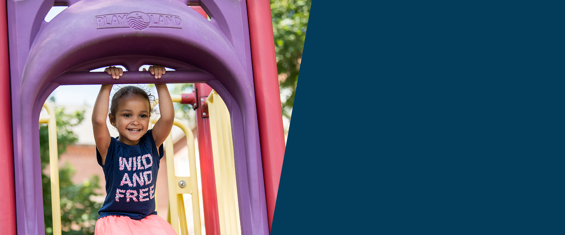 Young child about to go down a colorful slide