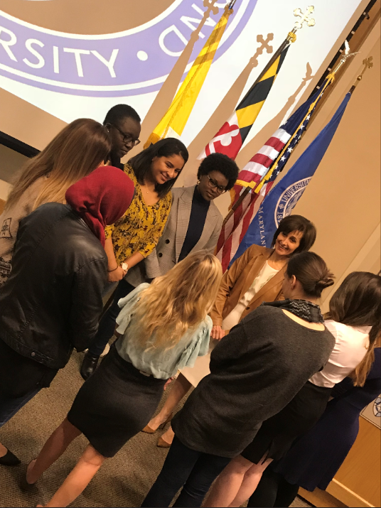 Dina Kawar speaks with a group of students