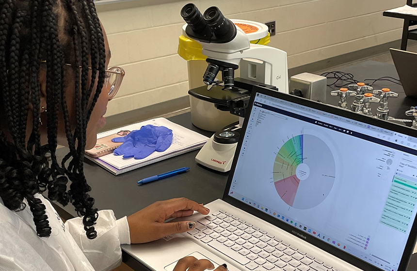 An NDMU student working in a bio lab