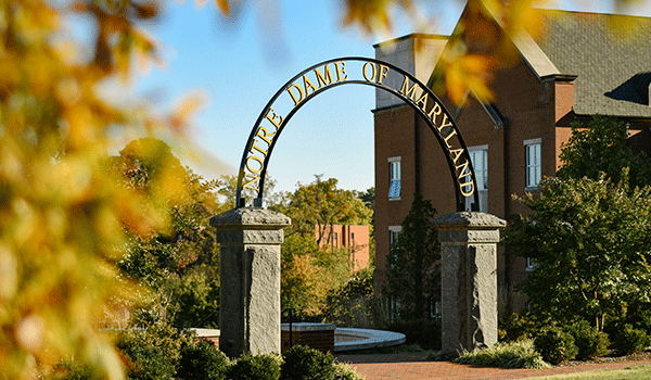 NDMU Arch surrounded by fall leaves