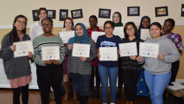 Group of students holding certificates of recognition