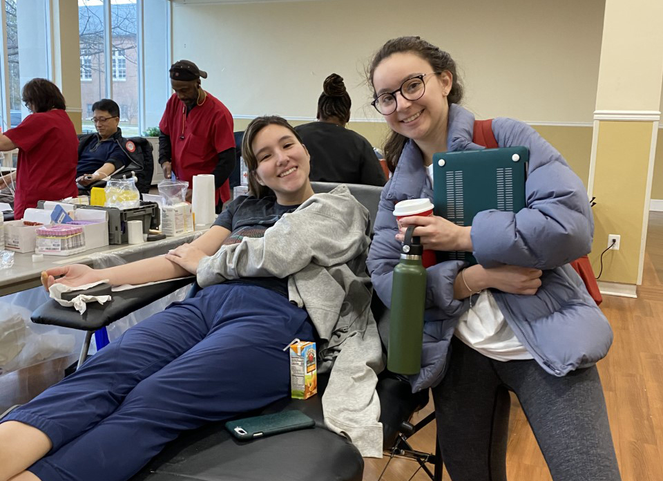 student donates blood during blood drive