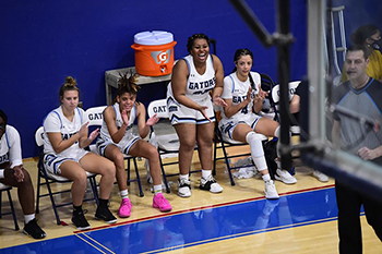 Women's basketball cheering on their teammates