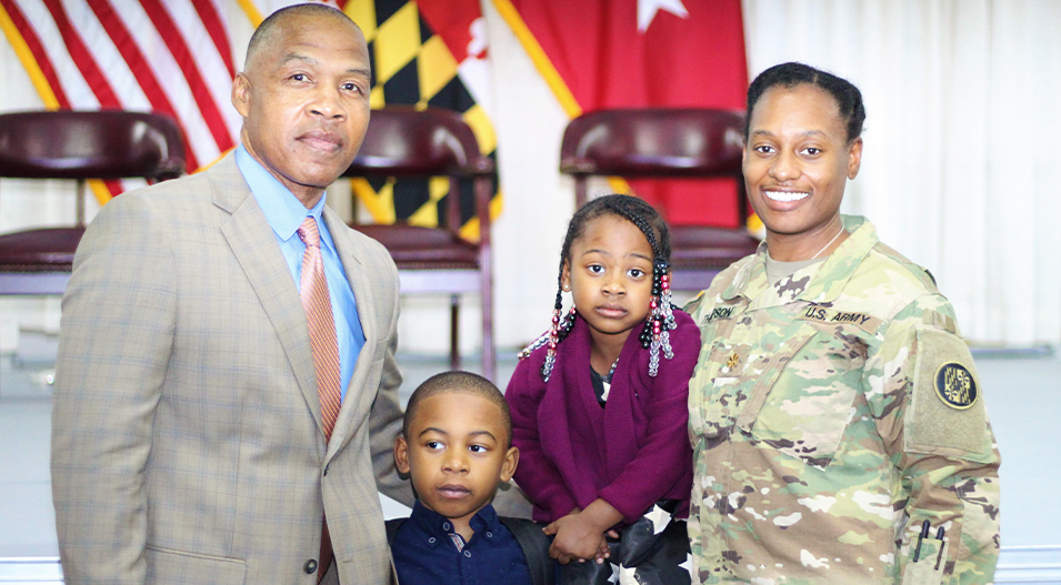 Candice Thompson in military fatigues with her husband, daughter, and son