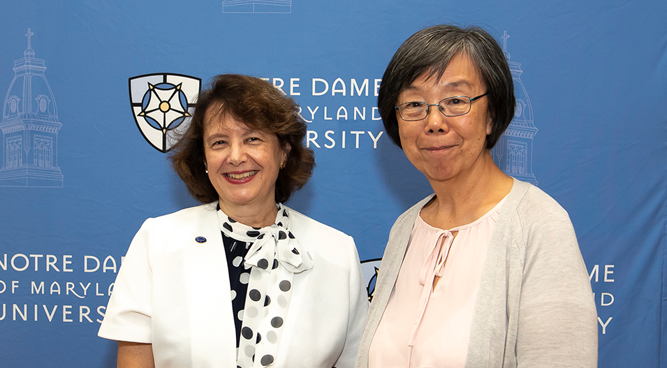 Helen Liu with President Yam in front of NDMU backdrop