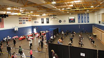 An overhead view of a vaccination clinic at MBK Gymnasium