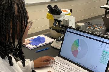 An NDMU biology student working in a classroom