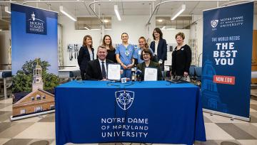 Presidents from NDMU and the Mount at a ceremonial agreement signing