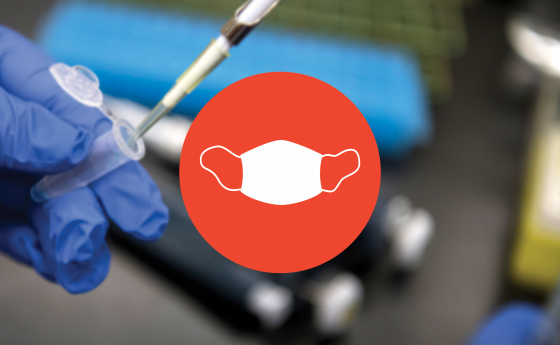 Photo of gloves holding a test tube with red mask icon on top