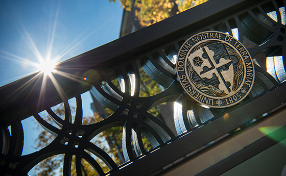 Close up of an ornate sign with the NDMU seal