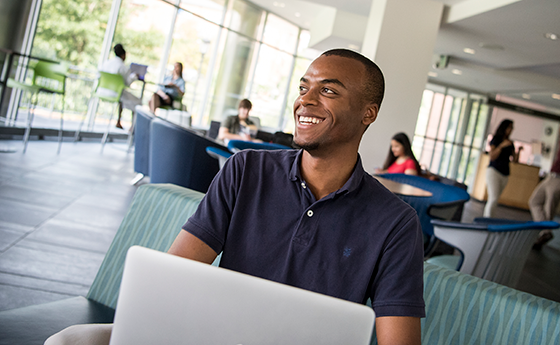 Male student on a laptop