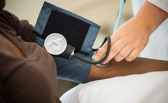 close up of a blood pressure cuff on a woman's arm
