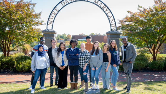 a group of student near arch