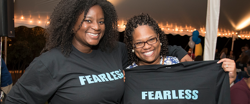 Two women wearing "fearless" shirts