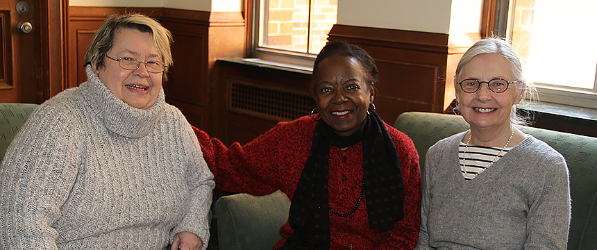 Three female members of the Renaissance Institute sitting on a couch