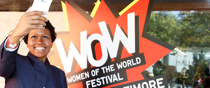 Women taking a selfie next to WOW logo