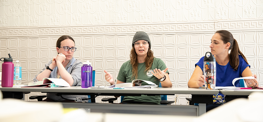 Three students having a class discussion